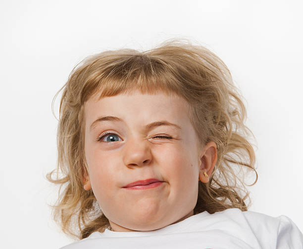 istock Blonde baby girl winking on white background 159345700