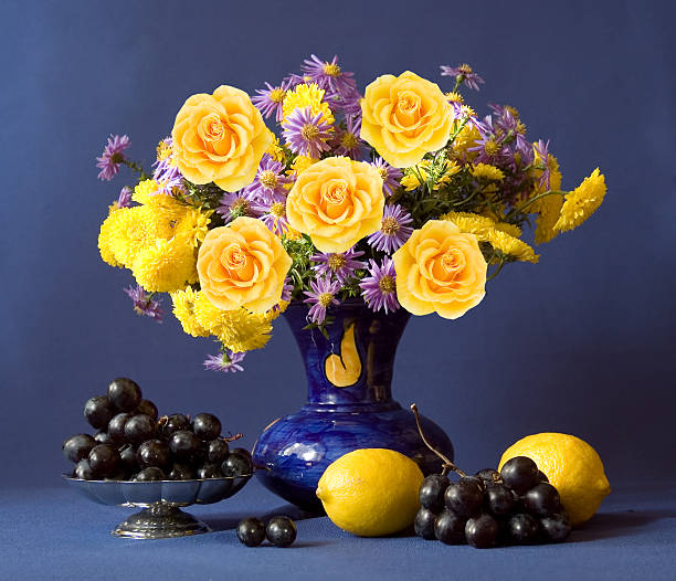 Still life with flowers bunch and fruits stock photo