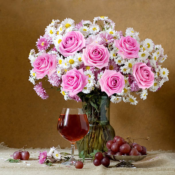 Still life with flowers bunch, wine and fruits stock photo