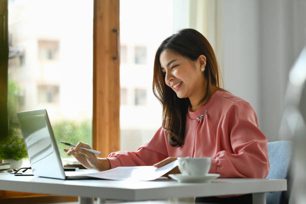 istock Charming asian woman working on online marketing, using laptop computer at workplace. 1593461149