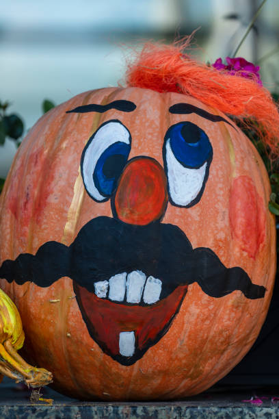 Happy ukrainian man face on painted pumpkin, close up. Ukraine