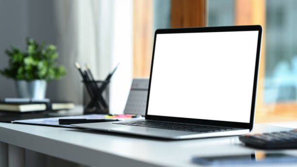 istock Home office interior , laptop computer with blank screen and office supplies on white table. 1593461666