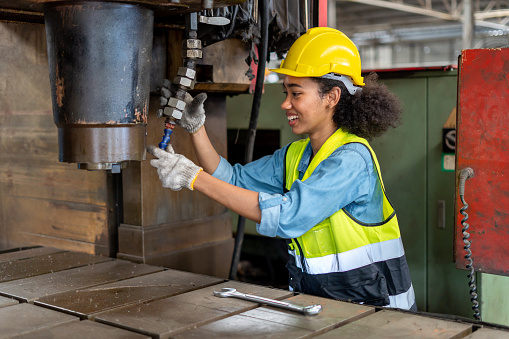 african american Mechanical engineer woman working with monitor controller in metal Heavy factory industries . black worker female control machine in warehouse Workshop