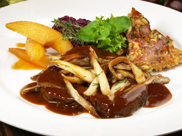 istock Deer Roast with Mushrooms and red Cabbage 1593468643