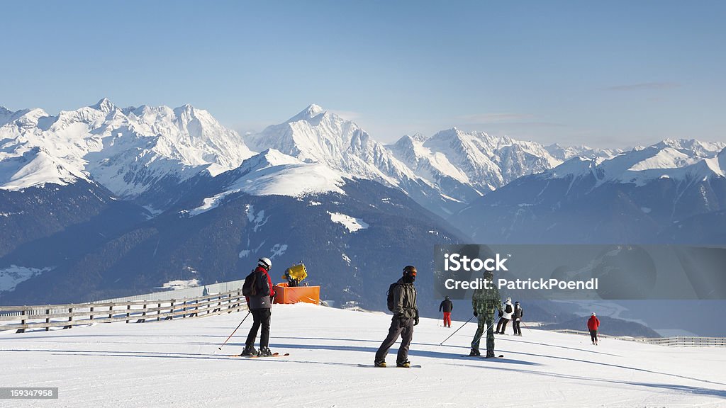 Skiers Enjoy Fantastic Alpine Panorama Skiers enjoy the fantastic alpine panorama on a sunny winter day. Kronplatz Stock Photo