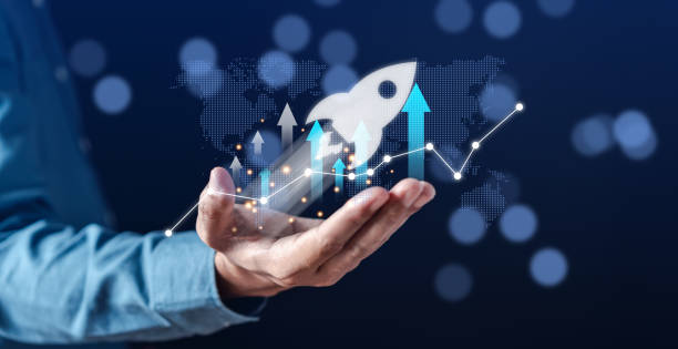 Businessman hold virtual rocket launch investment growth, planning and starting corporate business start up aiming objective value development leadership and customer target group.