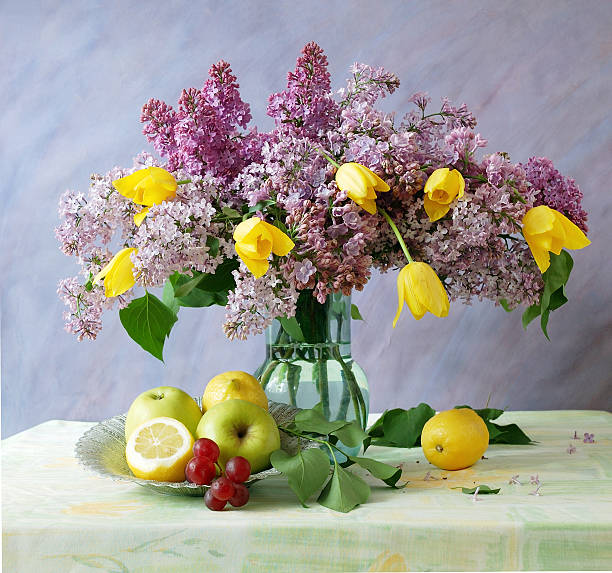 Still life with flowers bunch and fruits stock photo