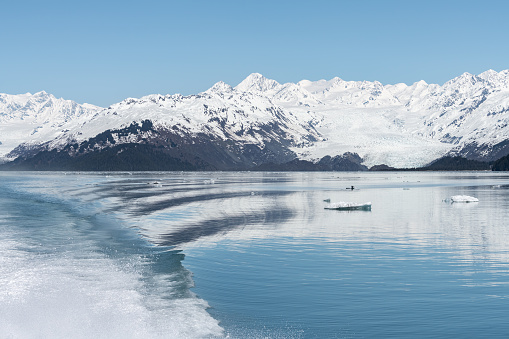 Yale Tidewater Glacier at the end of College Fjord and ships wake on a clam sea, Alaska, USA