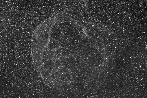Supernova remnant Sh2-240 (Simeis 147) Spaghetti Nebula spreading over Taurus and Auriga (monochrome image)