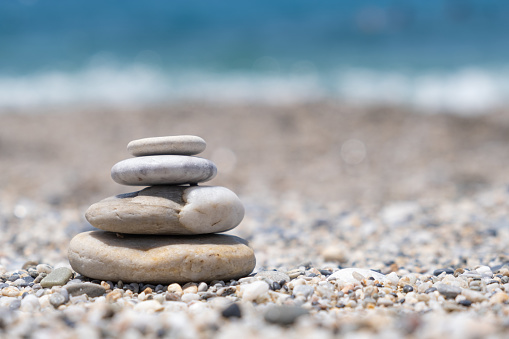 Pyramid of sea pebbles on the seashore. Zen relaxation and meditation concept