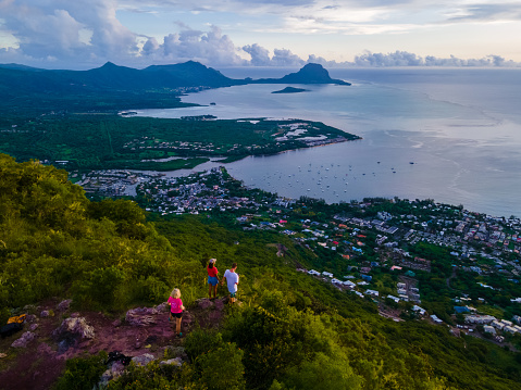 Man and Woman standing on a viewpoint at the mount Tamarin in Mauritius, a couple on a honeymoon vacation in Mauritius