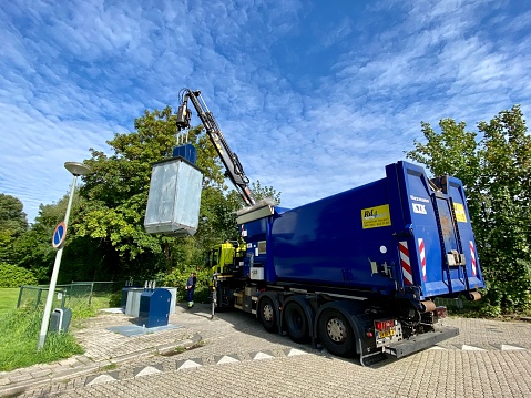 Brunssum, Netherlands - August 05,  2023.  Waste paper company unload the container with a special truck.