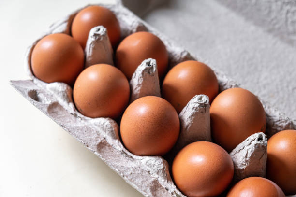 istock A few brown eggs among the empty cells of a large cardboard bag 1593606505