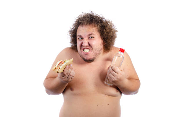 istock Diet and poor nutrition. Funny fat man posing in the studio. 1593628482