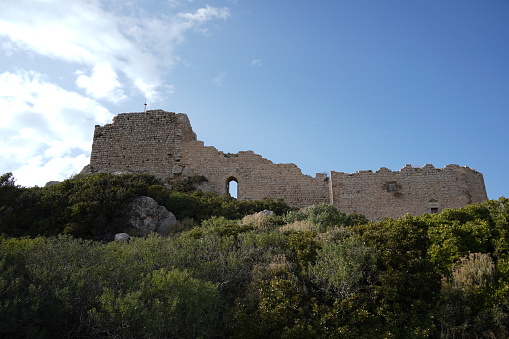 Ruins of the abandoned medieval Dothia fortification (fort, fortress, castle or tower) near Emporios (or Emborios) village on Greek Island of Chios on a sunny day in summer. It is one of several similar fortifications used by the Genovese to protect themselves and police the region. From this and other watchtowers communication was performed with smoke signals during the day and fire signals during the night. The ruins is the property of the Greek state and open to the public with no restrictions on publishing photographs of the (historic) site.