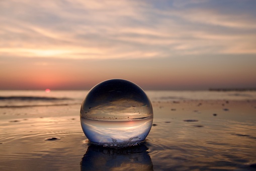 Crystal ball at sea during sunrise