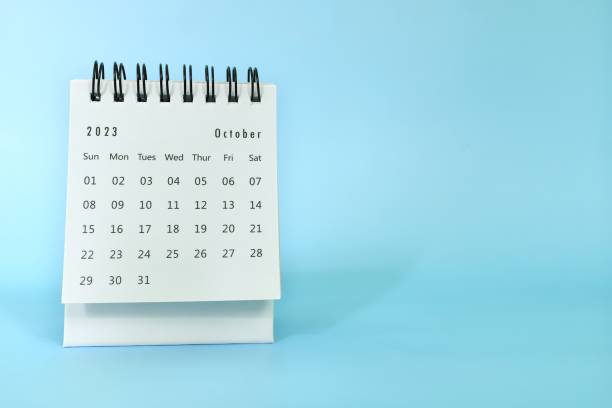 istock Selective focus of October 2023 desk calendar on blue background with copy space. 1593660945