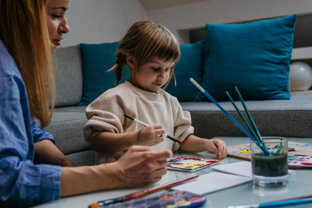 istock A side-by-side comparison of a mother and her daughter's individual paintings, reflecting their distinct styles and shared creative energy. 1593671018