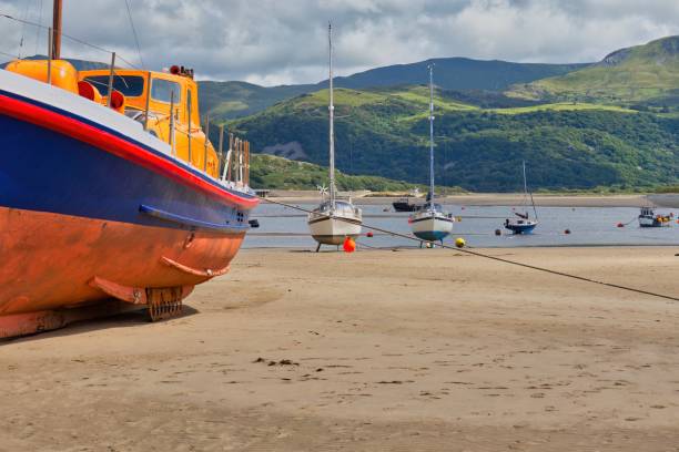 istock boat on the beach and green mountains 1593677460