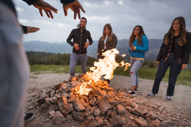 istock friends in front of the campfire all together 1593710400