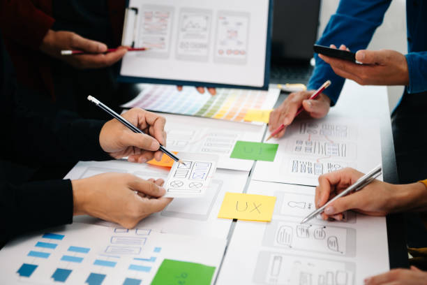 istock Close up view of UI developer team brainstorming on their project with laptop, smartphone and digital tablet. Creative digital development agency. 1593741773