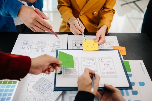 istock Close up view of UI developer team brainstorming on their project with laptop, smartphone and digital tablet. Creative digital development agency. 1593742320