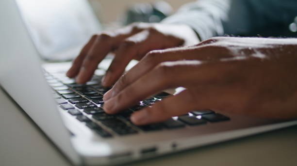 istock Guy hands typing keyboard laptop at apartment closeup. Man arms pressing buttons 1593752434