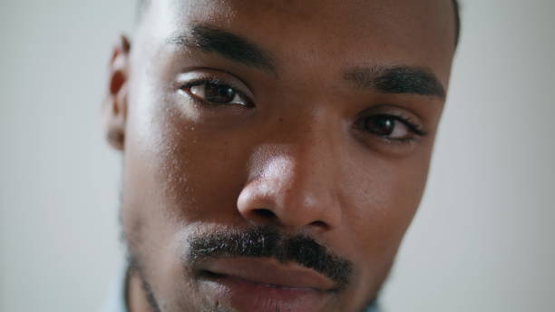 istock Serious man looking camera home alone portrait. Brown skin student staring lens 1593755713