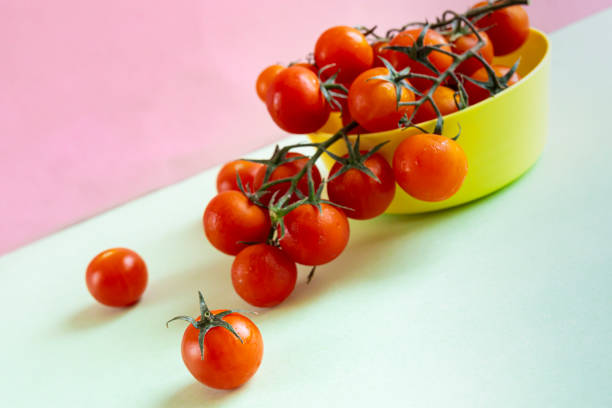 istock Diagonal perspective of a yellow bowl with cherry tomatoes 1593765310