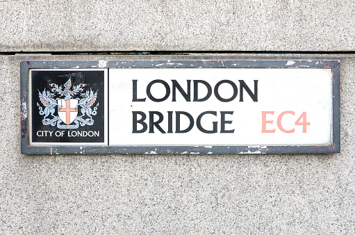 Street Sign of London Bridge along with the City of London logo and coat of arms, signage of popular tourist location in the capital