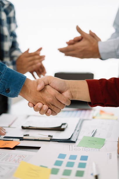 istock designer team shake hands confidently professional investor working with new startup project at an office meeting. 1593788787