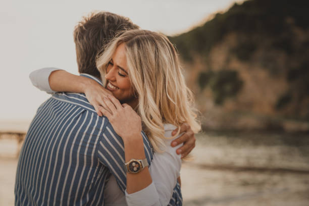 istock Lovely couple hugging at the beach 1593793255