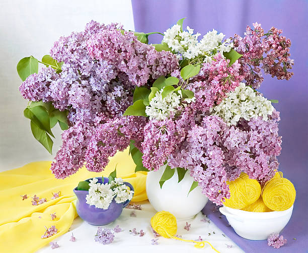 Spring still life with flowers bunch and wool hank stock photo