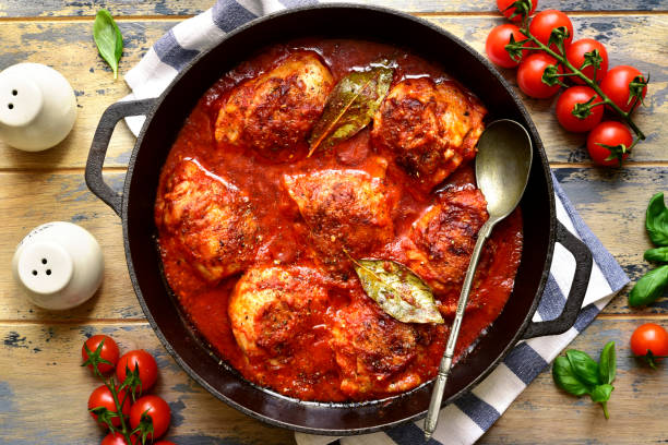 istock Chicken thigh stew in tomato sauce with vegetables. Top view with copy space. 1593805556