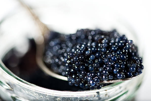 Black caviar Black caviar in the spoon caviar stock pictures, royalty-free photos & images
