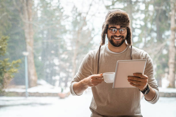 istock Handsome man having a video call on winter vacation 1593819264