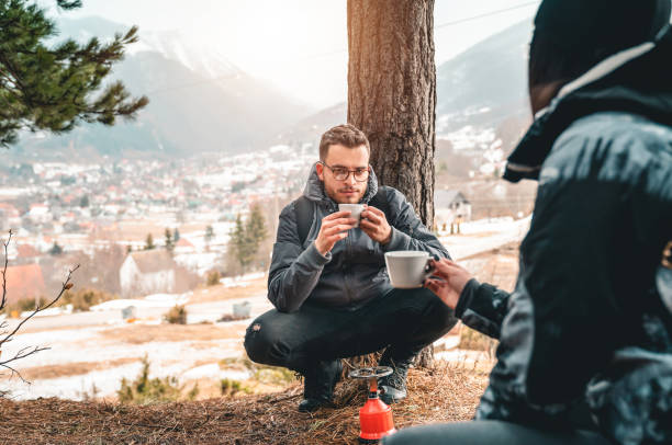 istock Young hikers enjoying hot tea in the mountains while taking a break 1593822045