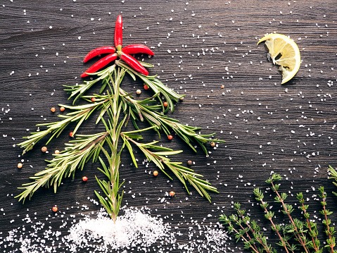 Flat lay on black background: Christmas Tree and Snow made of spices: Culinary New Year's Card