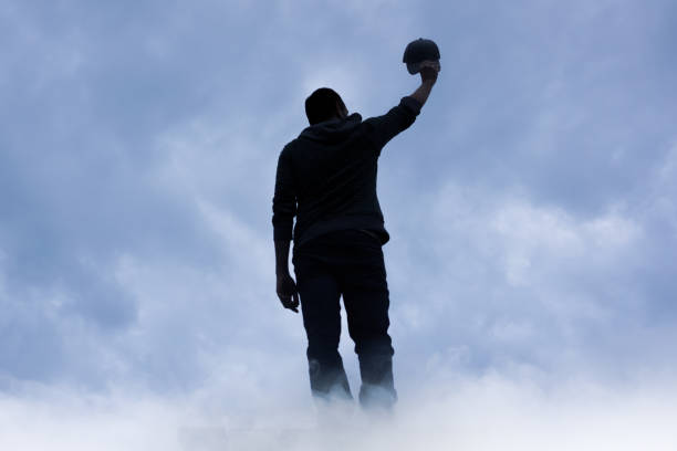 man silhouette among clouds in the mountain