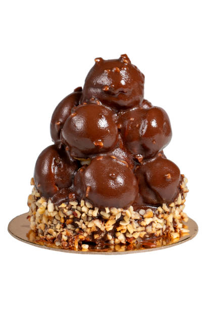 istock Profiterole cake with chocolate sauce isolated on white background. Cream and chocolate cake 1593833298