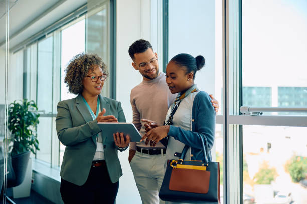 istock Young couple and their financial advisor using touchpad during the meeting. 1593908581