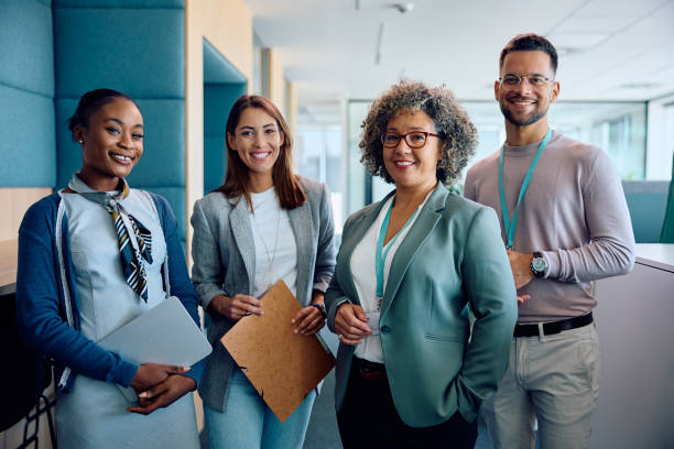 istock Happy multiracial business team in the office looking at camera. 1593909868