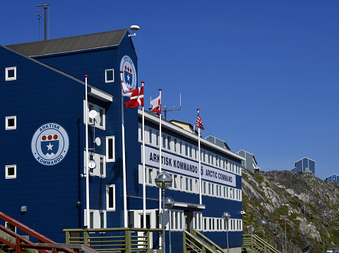 Nuuk / Godthåb, Sermersooq, Greenland: blue façade of Danish Joint Arctic Command headquarters (JACO), located by the harbor - Arktisk Kommando - The mission of the Joint Arctic Command is to protect the sovereignty of the Kingdom of Denmark, a NATO member, in the Arctic Region. It's area of responsibility extends from the Faroe Islands to the Greenland Sea and the Arctic Sea to the North, and across the Denmark Strait and the Irminger Sea to the Davis Strait and Baffin Bay between Canada and Greenland.