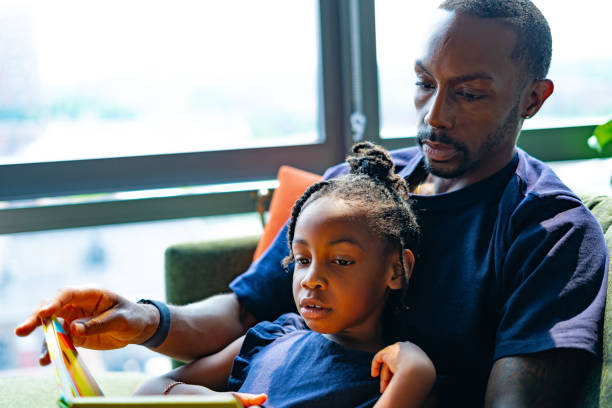 istock FatherHood | Reading Together. 1593925696