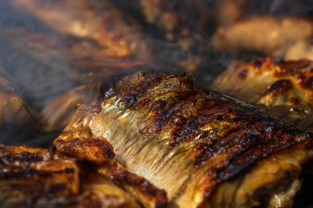 istock Grilled mackerel fish with smoke on a charcoal barbecue grill. 1593964492