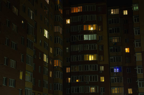 istock Multiflat apartment building lights at night. 1593981882