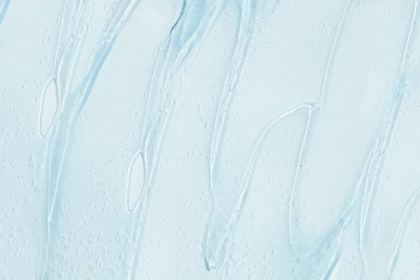 istock Flowing transparent gel on a blue background. Banner with empty space for advertising. 1594022788