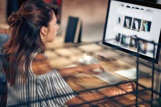 istock Young woman with coffee looking at computer, browsing on the internet. 1594032920