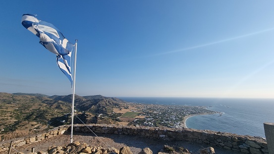 greece greek flag waving by the wind in sunny day and blue sky in greek island skyros