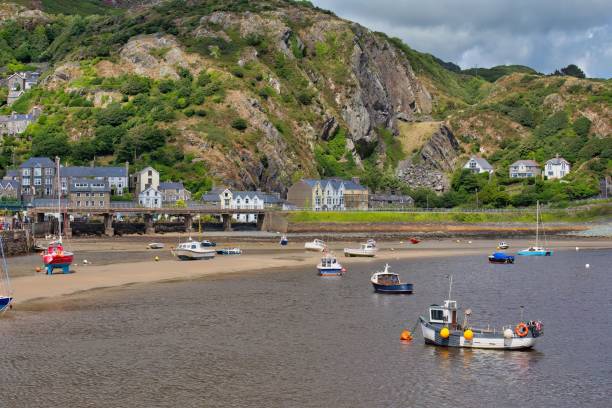 istock boats on the shore and town with mountains 1594036685